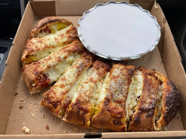 Baked stromboli with melted cheese and banana peppers